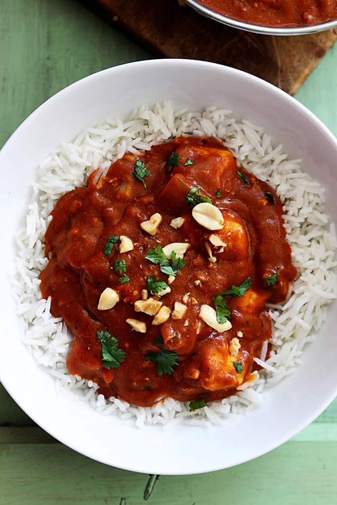 top view of Indian butter chicken on rice in a bowl.