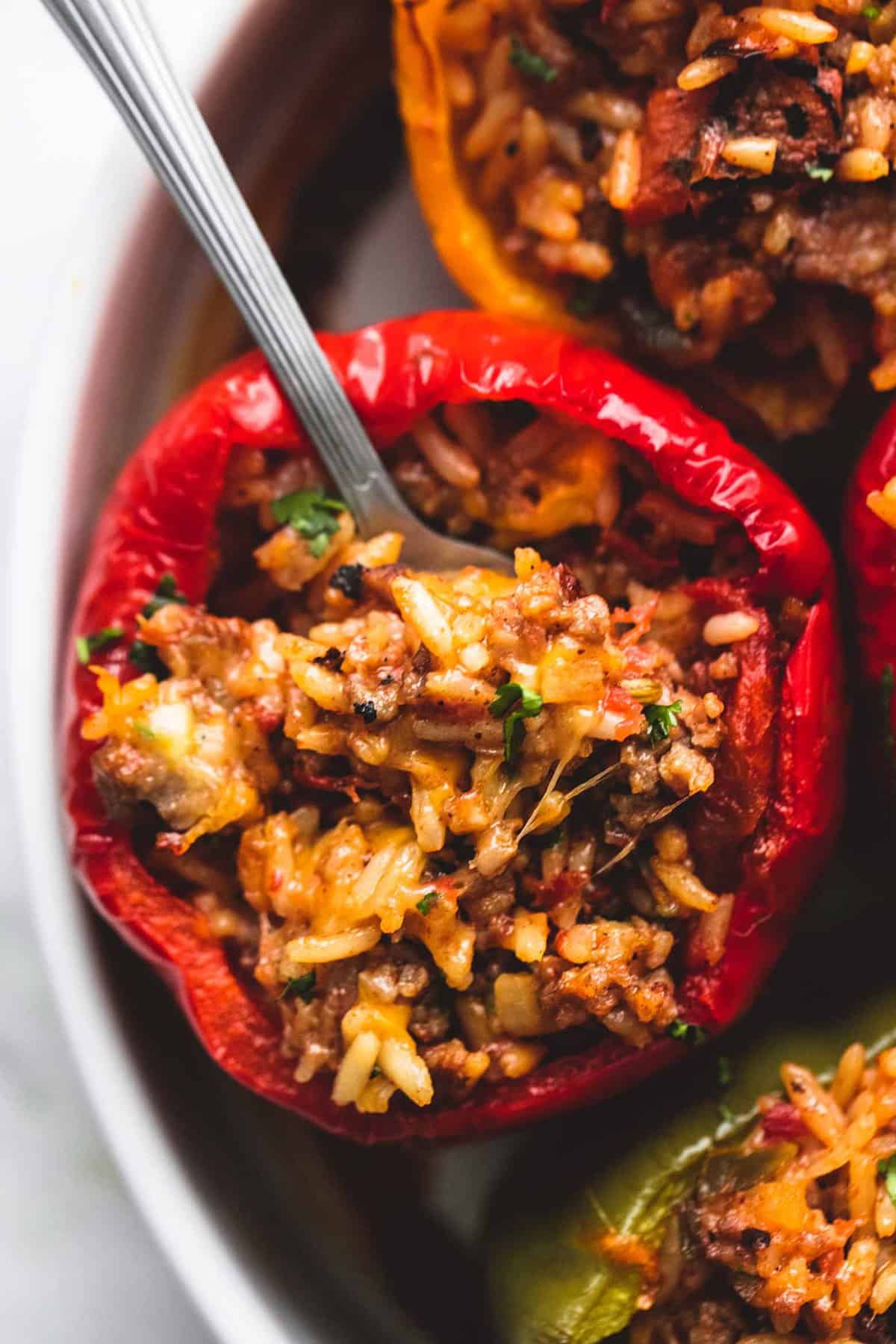 close up top view of a stuffed pepper with a spoon in it.
