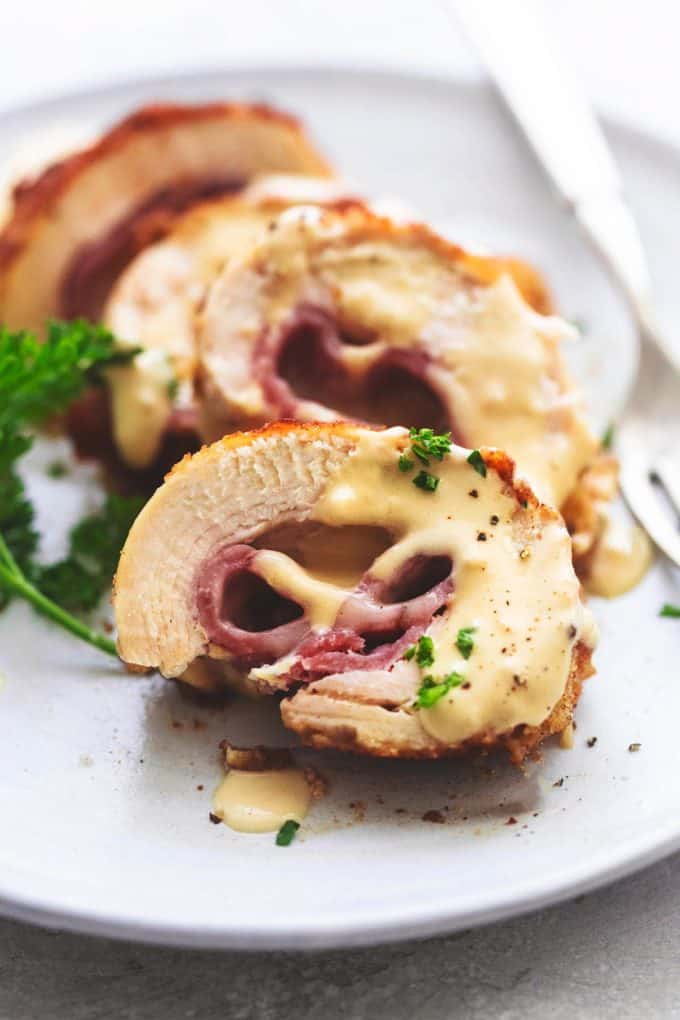 sliced chicken cordon bleu with creamy sauce on a plate