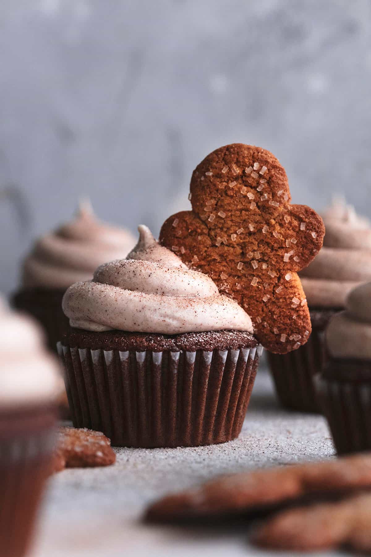 gingerbread cupcake with frosting and gingerbread man topper