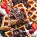 up close view of quartered waffles on a platter with toppings