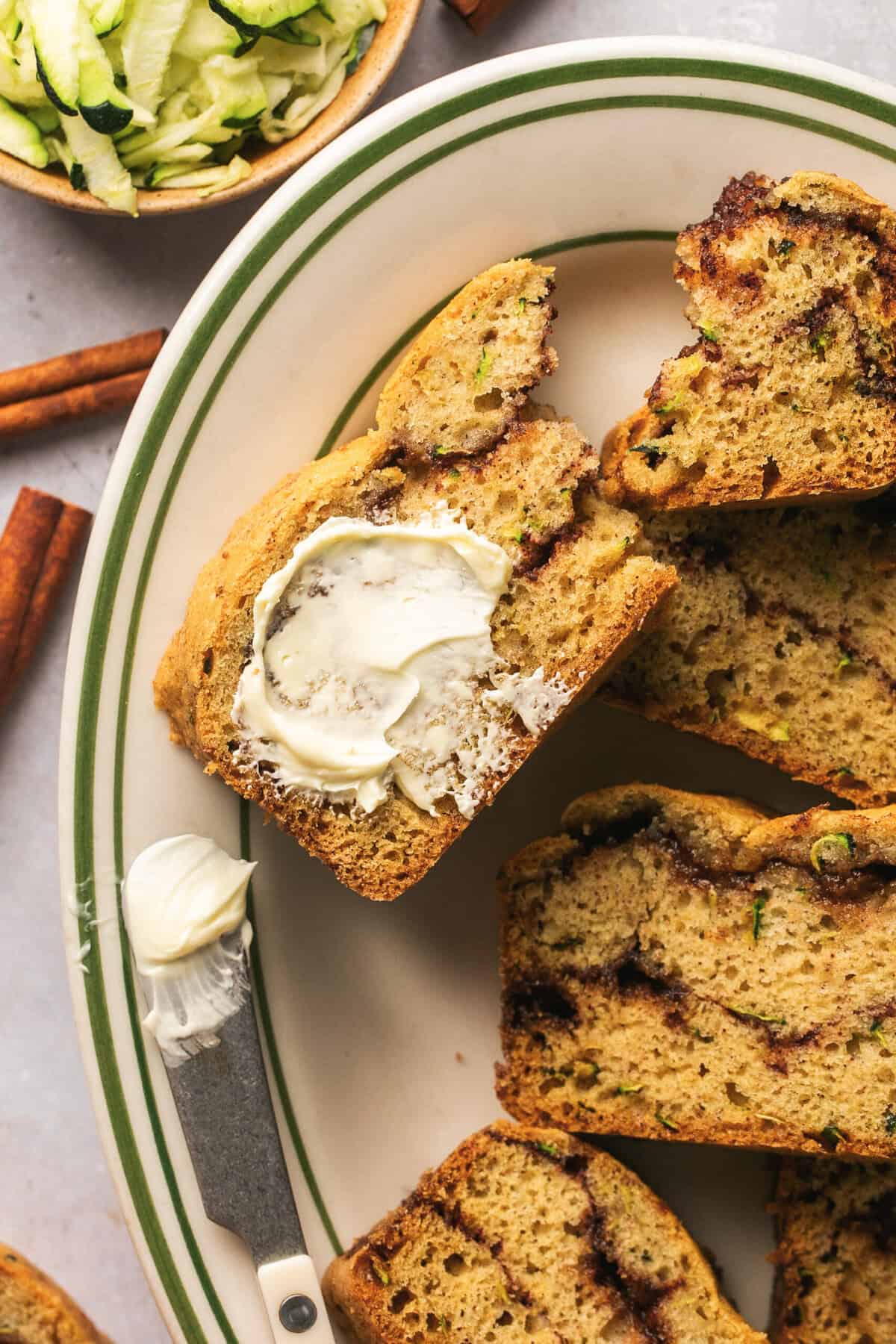 piece of cinnamon zucchini bread with butter smeared