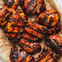 platter of grilled chicken thighs with bbq sauce