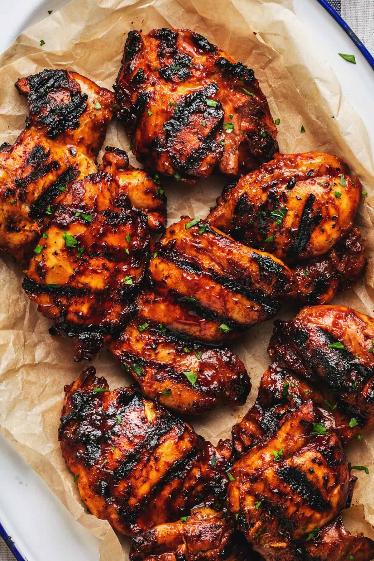 platter of grilled chicken thighs with bbq sauce 
