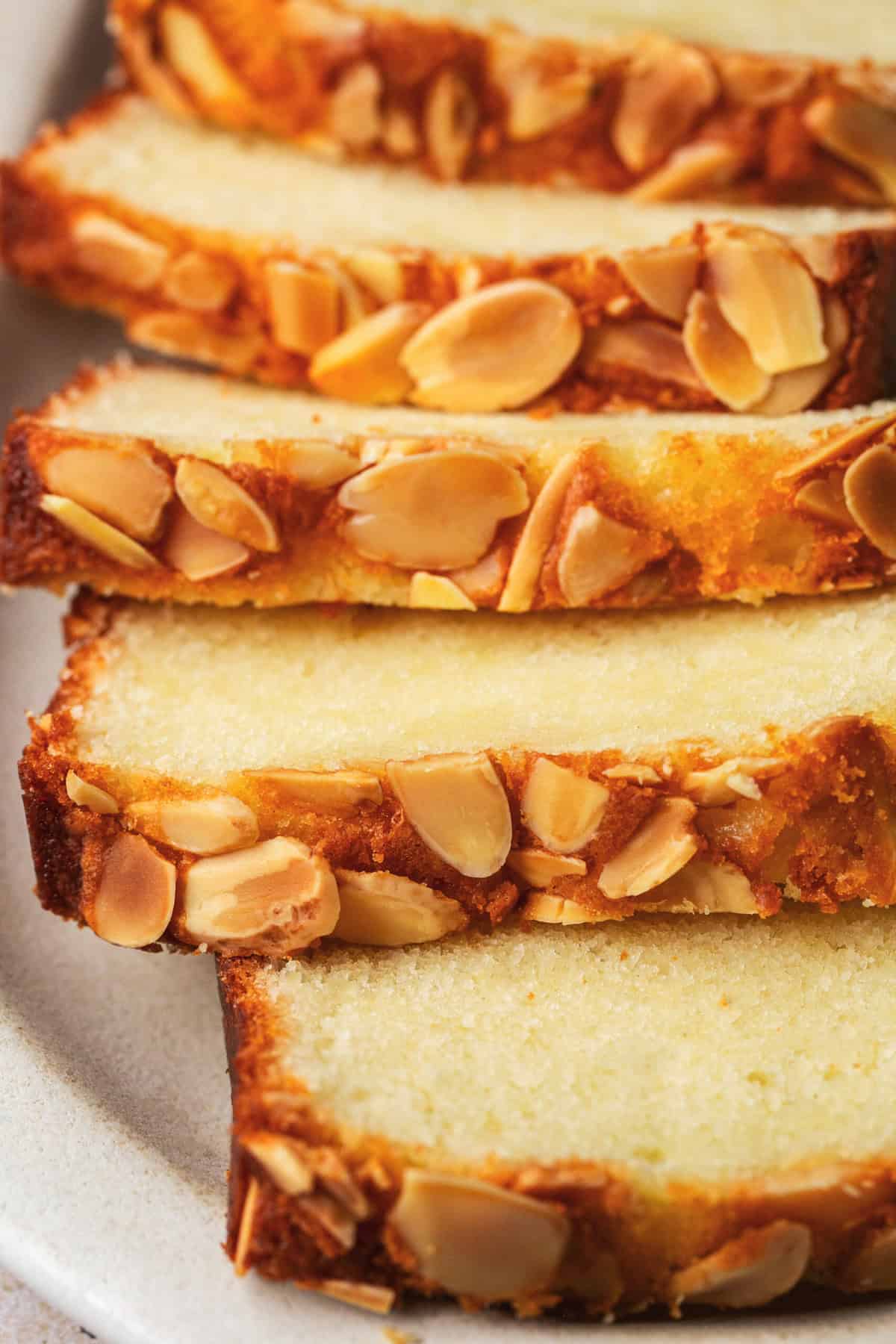 sliced almond cake with slivered almonds on top