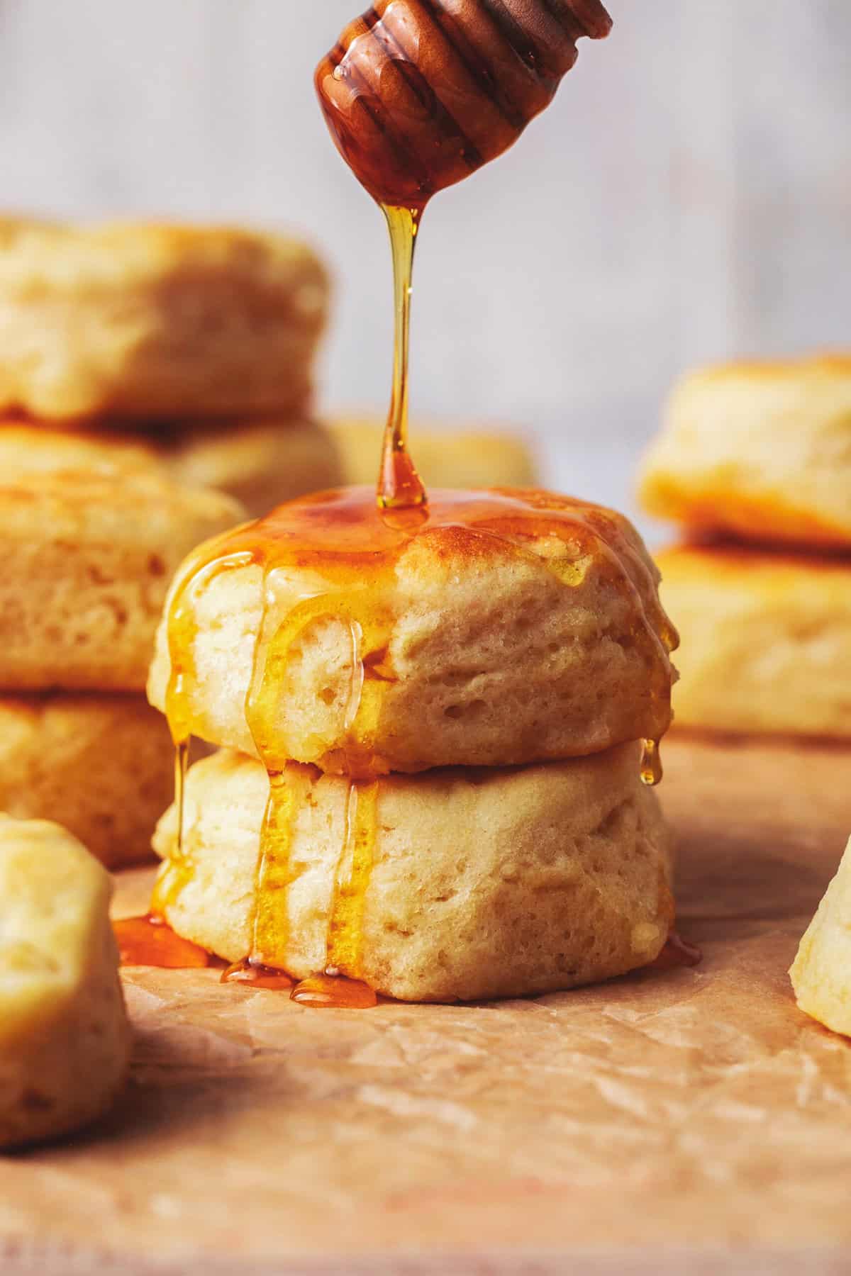 honey drizzling onto stack of biscuits