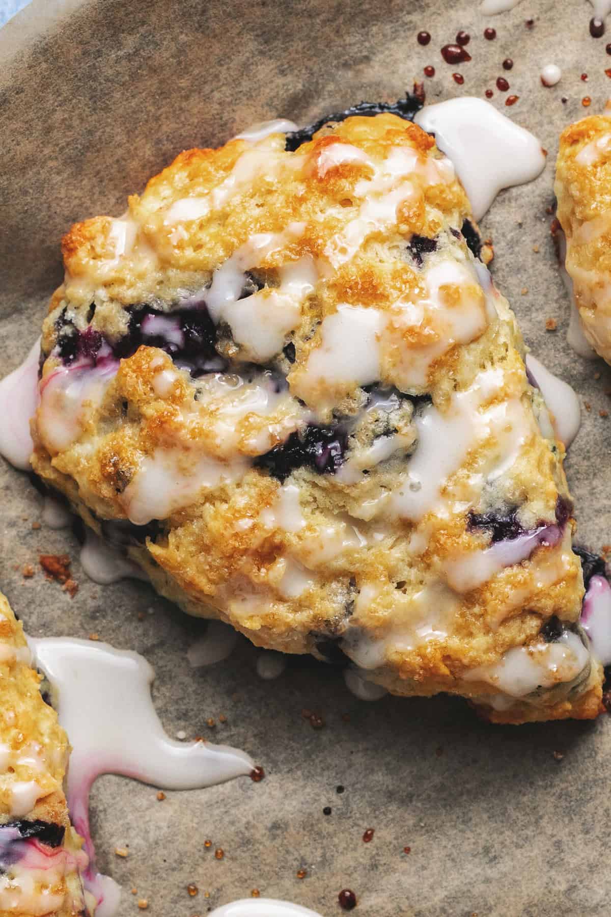 overhead view of one glazed blueberry scone