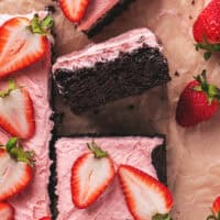 pieces of cake with strawberry frosting and strawberries