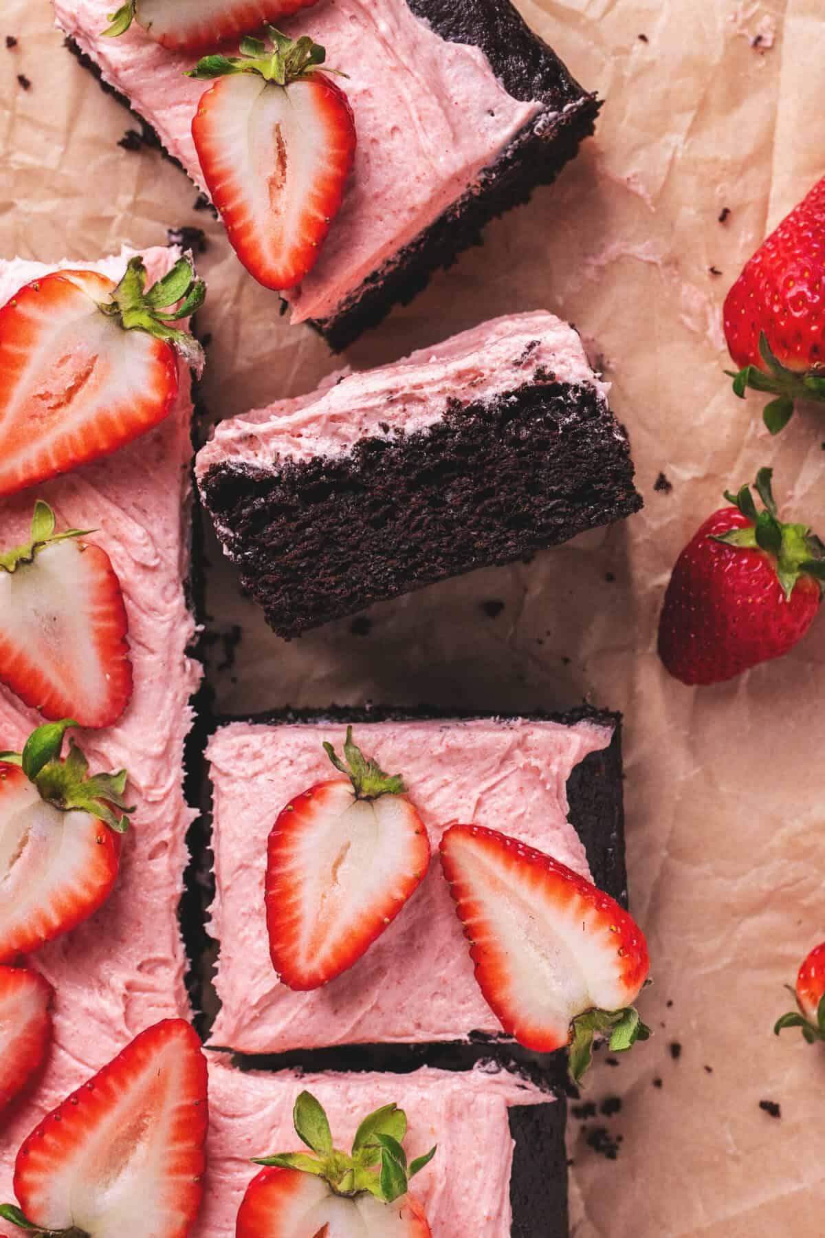 pieces of cake with strawberry frosting and strawberries