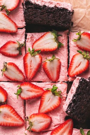 chocolate cake with strawberry frosting and fresh strawberry halves