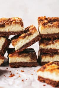 stacked cheesecake bars on parchment paper