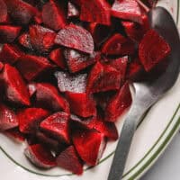 chopped, roasted beets with metal serving spoon