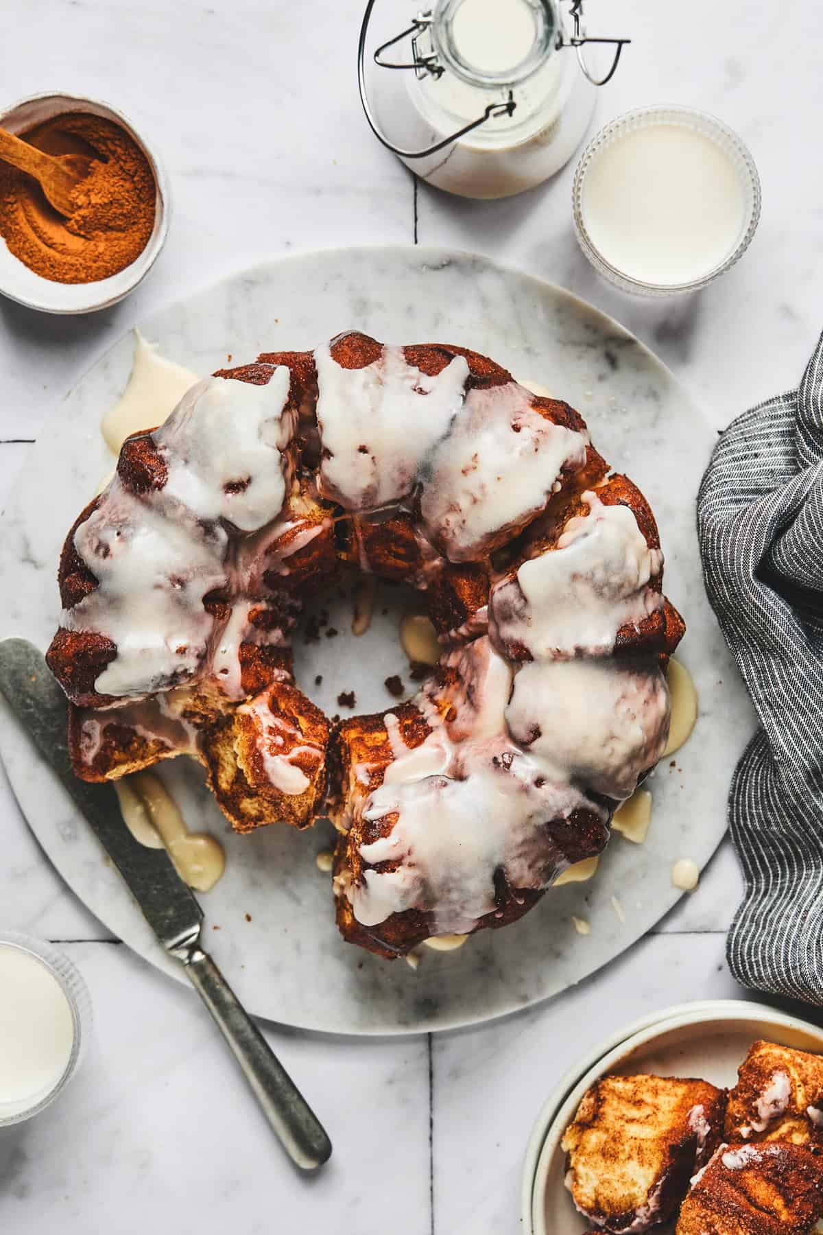 cinnamon roll monkey bread with some ingredients on the side