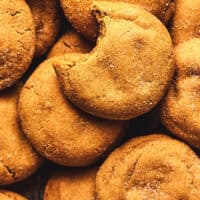 overhead view of chewy gingersnap cookies with one cookie missing a bite