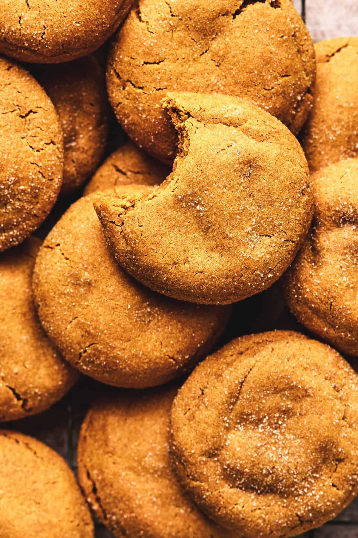 overhead view of chewy gingersnap cookies with one cookie missing a bite