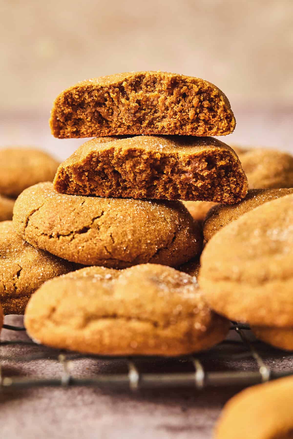 gingersnap cookie broken in half stacked on top of more cookies