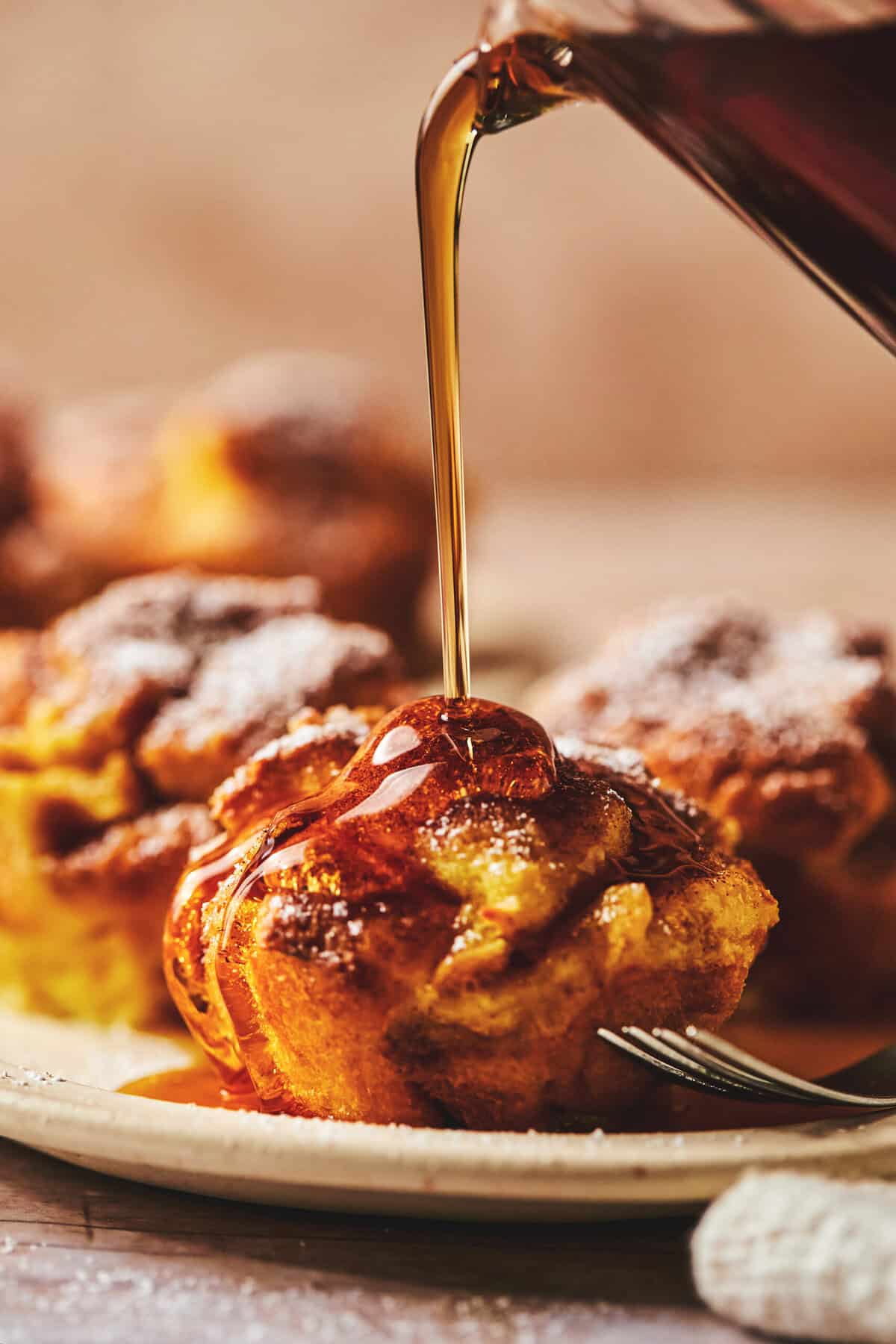 syrup pouring onto french toast muffin