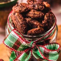 cinnamon pecans in a jar tied with a holiday ribbon