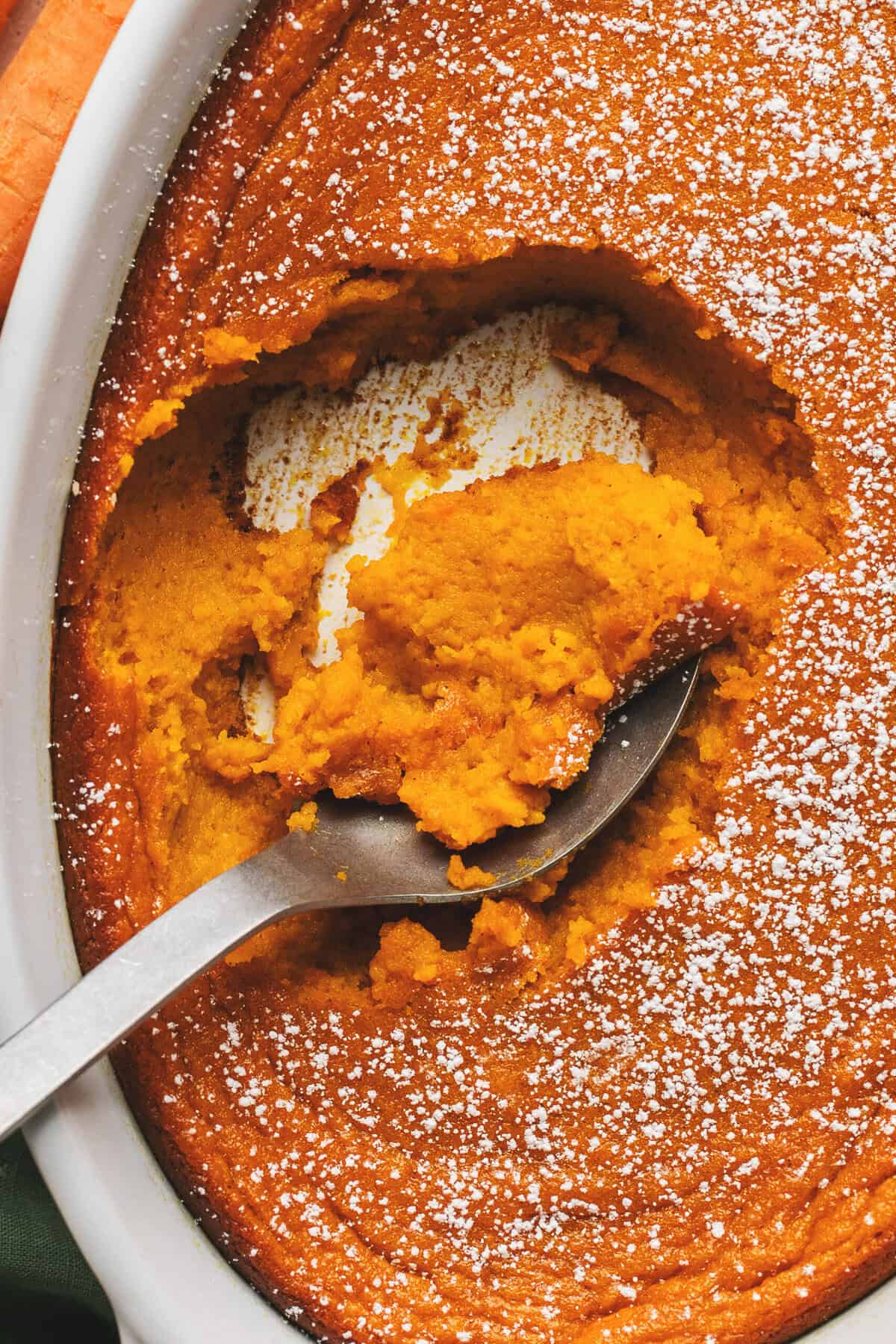 overhead view closeup of spoon scooping mashed carrots