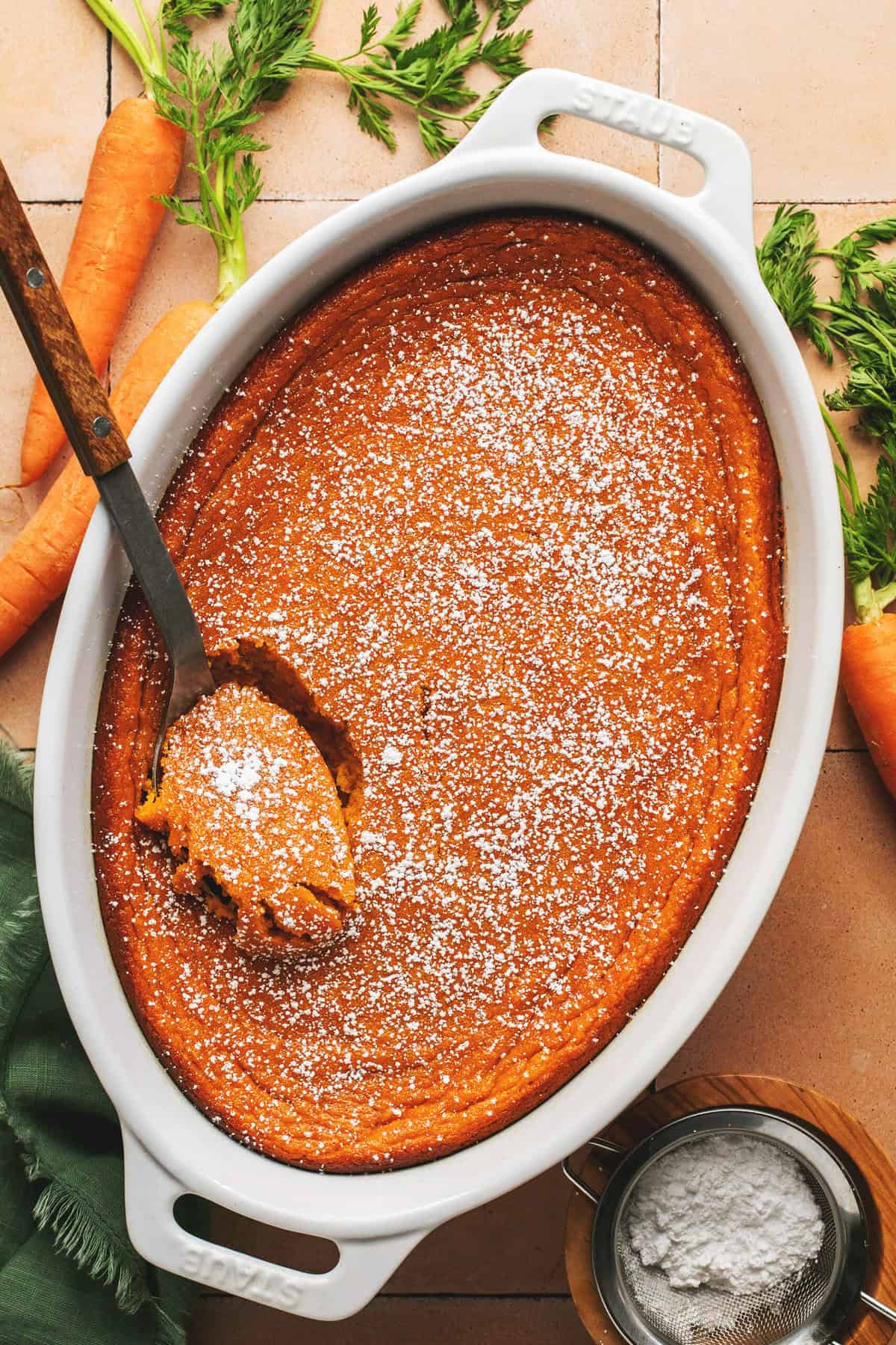 carrot souffle in serving dish with serving spoon