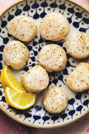 air fried scallops with lemon wedges on serving platter