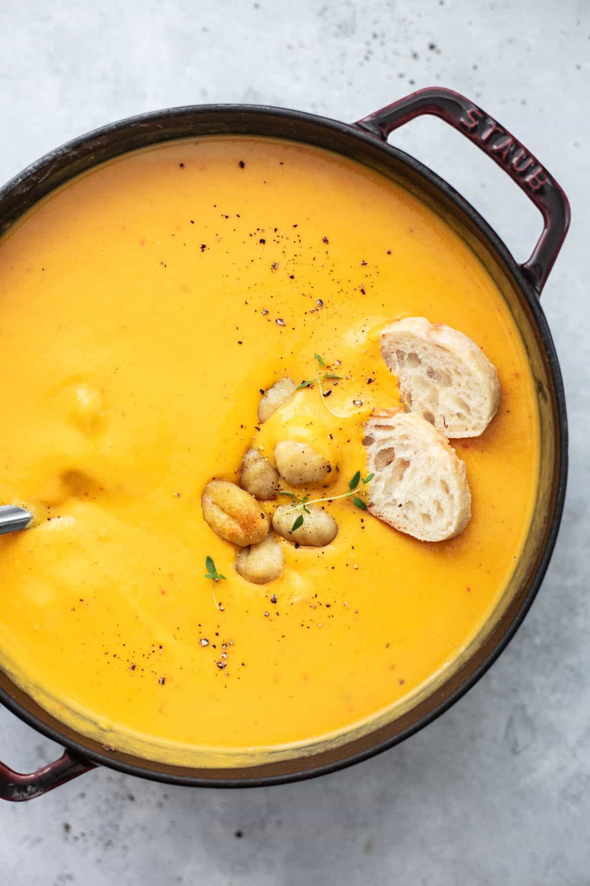 pot of butternut squash soup with bread and gnocchi