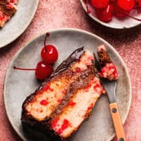 cherry chip cake with chocolate ganache frosting on plate with fork