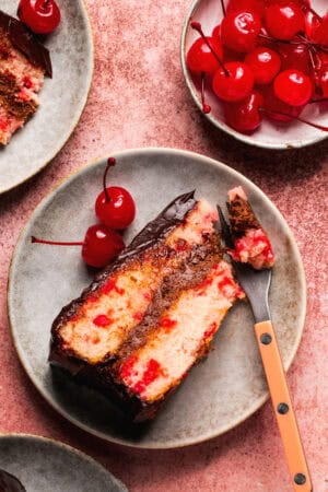 cherry chip cake with chocolate ganache frosting on plate with fork