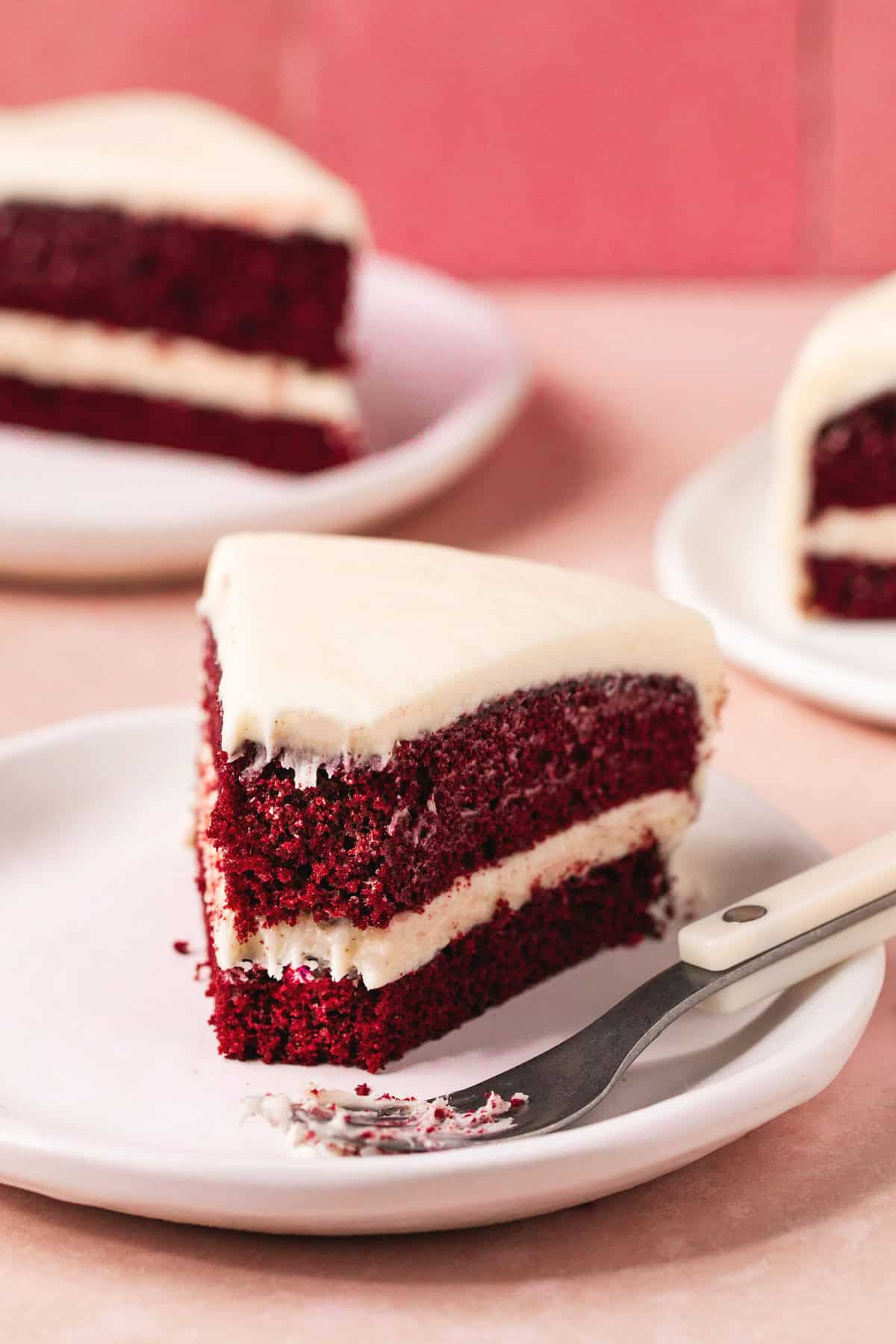 piece of red velvet cake on plate with fork